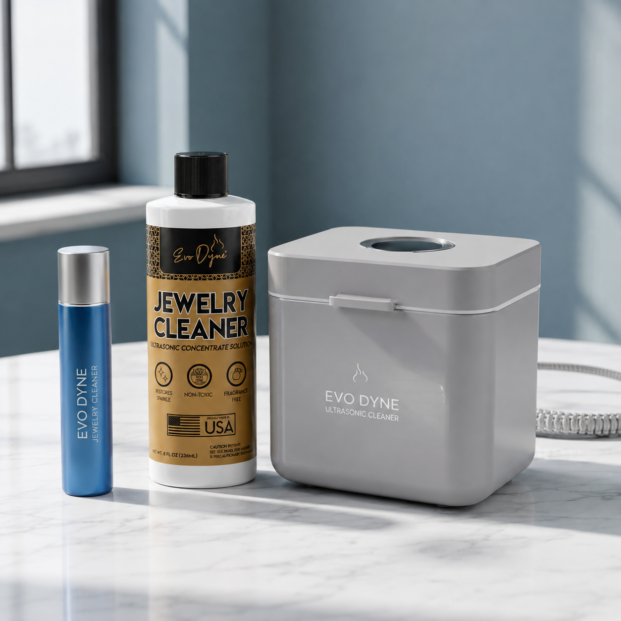 Sleek consumer goods products displayed on a marble surface with soft lighting.