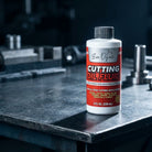 Evo Dyne cutting oil bottle beside calipers on a workbench